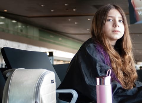 Teenager waits for the departure of her next plane