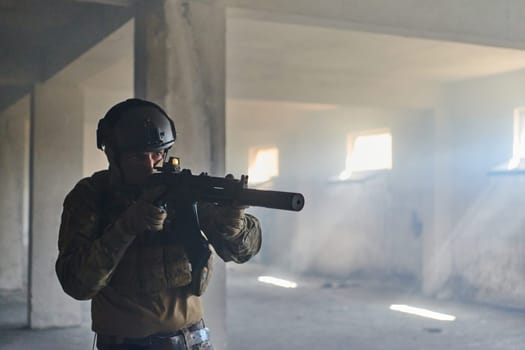 A professional soldier in an abandoned building shows courage and determination in a war campaign.