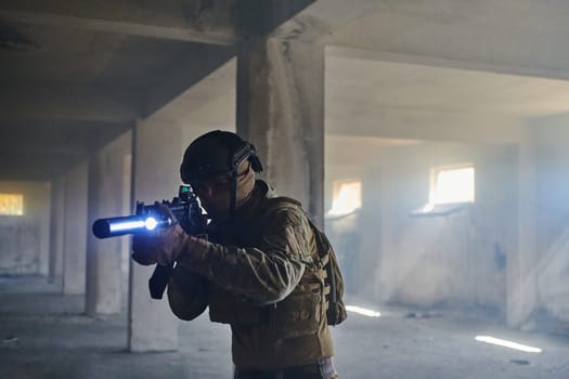 A professional soldier in an abandoned building shows courage and determination in a war campaign.