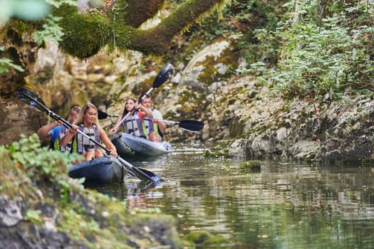 A group of friends enjoying having fun and kayaking while exploring the calm river, surrounding forest and large natural river canyons.