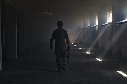 A professional soldier in an abandoned building shows courage and determination in a war campaign.