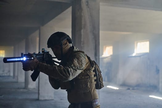 A professional soldier in an abandoned building shows courage and determination in a war campaign.