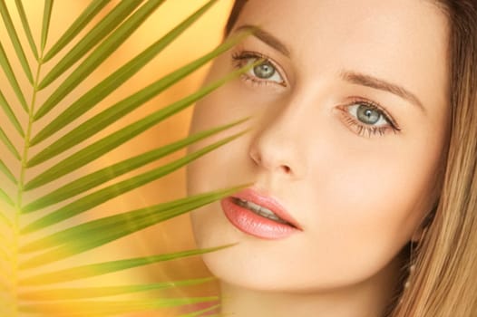 Summer beauty, makeup and skincare, face portrait of beautiful woman with tropical palm tree leaf, natural makeup for cosmetics and fashion look idea