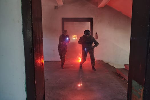 A group of professional soldiers bravely executes a dangerous rescue mission, surrounded by fire in a perilous building