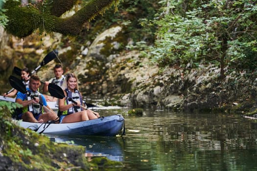 A group of friends enjoying having fun and kayaking while exploring the calm river, surrounding forest and large natural river canyons.