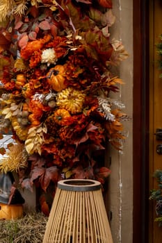 Fall cozy pumpkins in autumn outside. Thanksgiving or Halloween holiday decoration. House entrance in festive seasonal decor. Atmosphere aesthetic