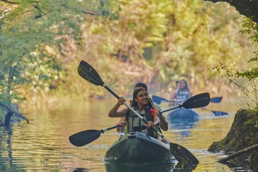 A group of friends enjoying having fun and kayaking while exploring the calm river, surrounding forest and large natural river canyons.