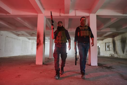 An abandoned building serves as the stronghold for a team of terrorists, fiercely guarding their occupied territory with guns and military equipment.