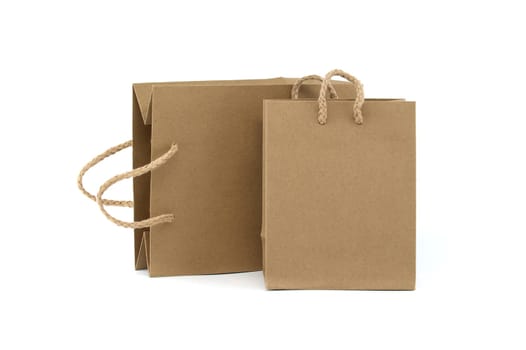 Two brown paper bags with a rope handle. The bags are of different sizes. The bags are placed next to each other