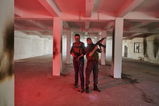 An abandoned building serves as the stronghold for a team of terrorists, fiercely guarding their occupied territory with guns and military equipment.