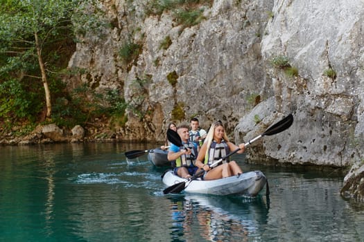 A group of friends enjoying having fun and kayaking while exploring the calm river, surrounding forest and large natural river canyons.