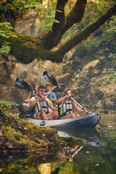 A group of friends enjoying having fun and kayaking while exploring the calm river, surrounding forest and large natural river canyons.