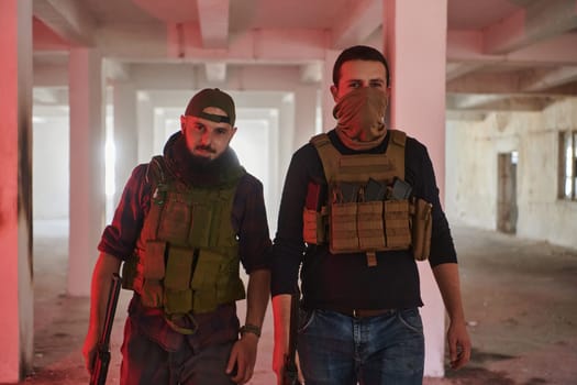 An abandoned building serves as the stronghold for a team of terrorists, fiercely guarding their occupied territory with guns and military equipment.