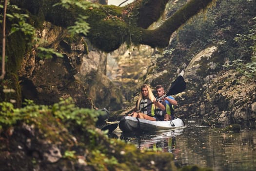 A group of friends enjoying having fun and kayaking while exploring the calm river, surrounding forest and large natural river canyons.