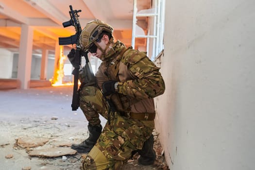 soldier in action near window changing magazine and take cover.