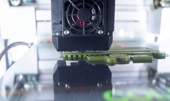 3D printer working close-up. 3D printer prints model from molten plastic close-up. 3D printer printing object. Additive progressive high-tech technology. New modern prototyping technologies.