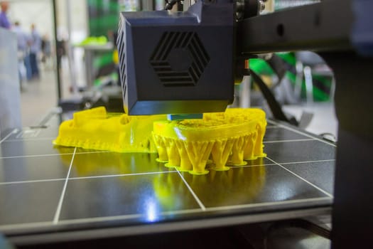 3D printer working close-up. 3D printer prints model from molten plastic close-up. 3D printer printing object. Additive progressive high-tech technology. New modern prototyping technologies.