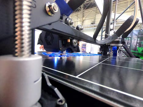 3D printer working close-up. 3D printer prints model from molten plastic close-up. 3D printer printing object. Additive progressive high-tech technology. New modern prototyping technologies