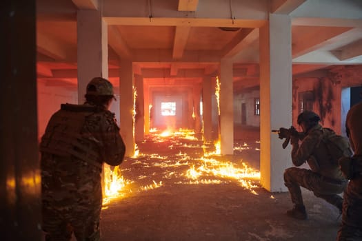 A group of professional soldiers bravely executes a dangerous rescue mission, surrounded by fire in a perilous building