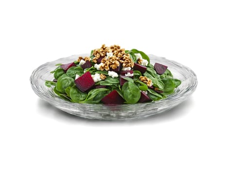 Autumn salad spinach with roasted beets goat cheese and walnuts served on a transparent glass. Food isolated on transparent background.