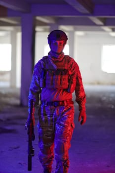 A professional soldier undertakes a perilous mission in an abandoned building illuminated by neon blue and purple lights.