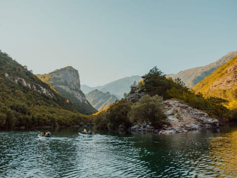 A group of friends enjoying having fun and kayaking while exploring the calm river, surrounding forest and large natural river canyons.