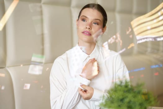 View from the glass of a beauty businesswoman adjusting elegant clothes in a cafeteria