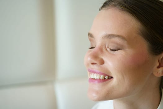 Side view close-up portrait of a happy elegant adult caucasian beauty businesswoman closing eyes dreaming in a cafeteria