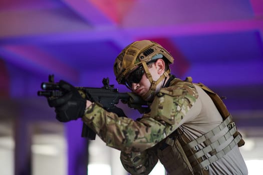 A professional soldier undertakes a perilous mission in an abandoned building illuminated by neon blue and purple lights.