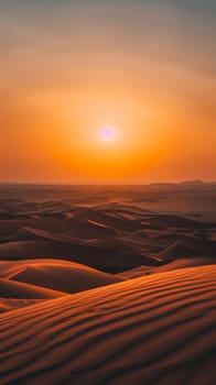 As the sun descends, its soft glow bathes the desert in a tranquil orange. Gentle winds sculpt the sands into waves of shadow and light