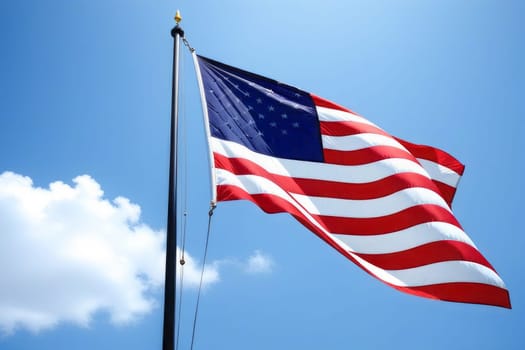 American flag develops against a blue sky. A symbol of country and freedom