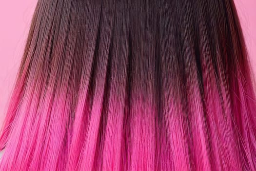 A captivating close-up view of the beautiful pink hair displays the artistic ombre technique, exuding a sense of glamour and refinement