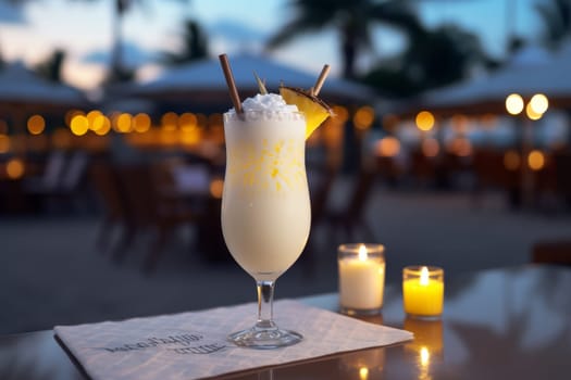 Beachside cafe table with summer coconut milk cocktail and pineapple pina colada drink
