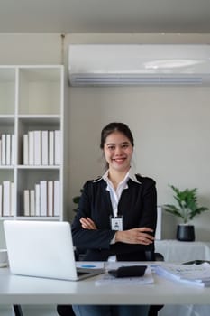 Confident businesswoman smiling in office. Concept of leadership, technology, and success.