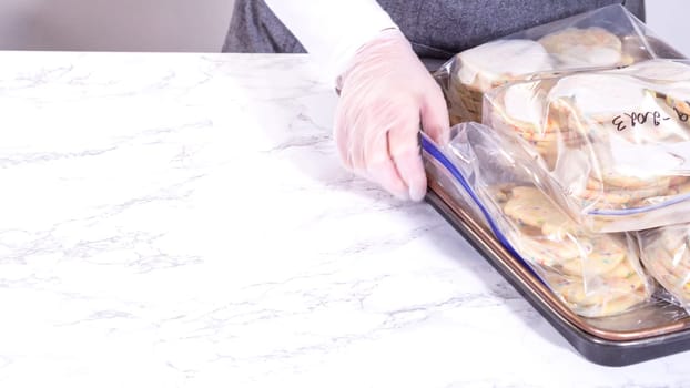 The sugar cookies, filled with sprinkles mixed into the dough, are carefully arranged with meticulous precision into a rustic brown paper box.