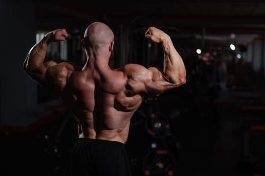 Caucasian bald man posing in the gym