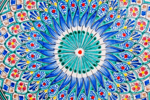 colorful pattern on Uzbek ceramic plates hand-painted close-up in oriental style