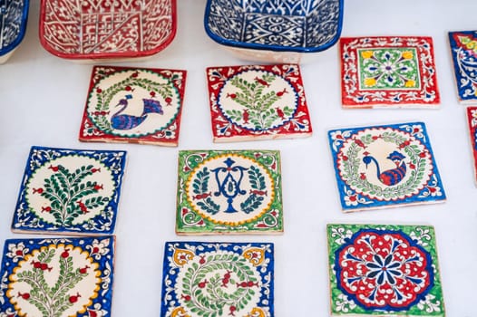 asian Uzbek handmade ceramic tiles with hand-painted traditional colorful patterns in pottery workshop in Uzbekistan in Tashkent