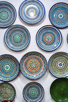 Uzbek handmade ceramic plates with hand-painted traditional ethnic Oriental Asian patterns in tableware store