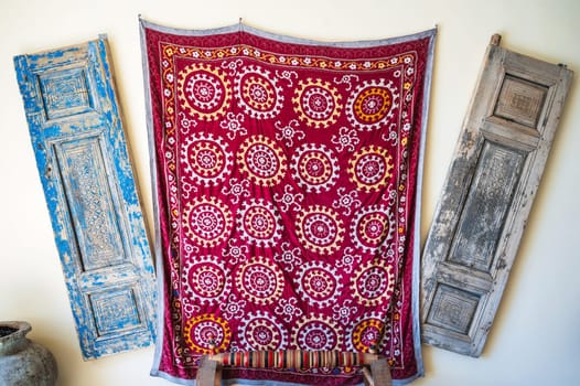 red vintage oriental Arabic carpets on a wall in Uzbekistan