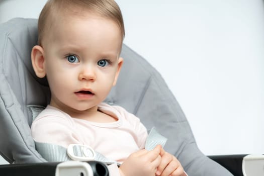 Close-up of an infant baby gazing at the camera with wide-eyed wonder