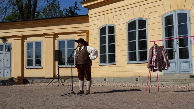 Uppsala, Sweden, May 18, 2024. A day at the Linnaeus Garden Party. 1700s theme. Microphone.