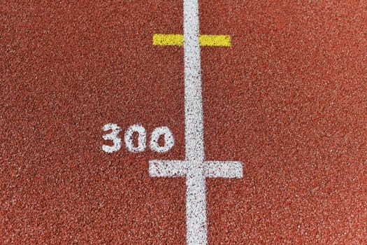 Three hundred meter mark on a running track at a stadium