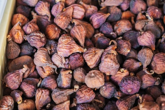 Dried figs on the counter of the oriental market in close-up. Healthy dried fruits at the bazaar