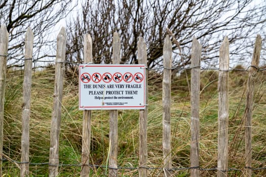 MURVAGH, COUNTY DONEGAL, IRELAND - JANUARY 21 2022 : Sign explaining that the dunes are very fragile.