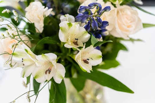 A stunning bouquet featuring fresh white roses and assorted flowers gracefully arranged in a vase, exuding timeless beauty.