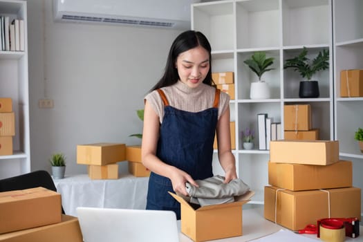 SME business entrepreneurs small in asia Preparing cardboard boxes in home office Small business operators preparing to ship to customers.