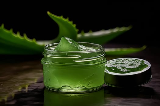 A jar of green aloe vera gel, ideal for moisturizing and caring for the skin, placed on a table next to a leaf.