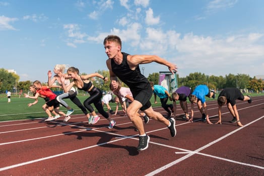 Group of young athlete runnner are training at the stadium outdoors