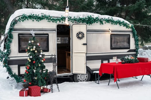 Campervan motorhome in winter camping decorated for Xmas or Happy New Year holiday